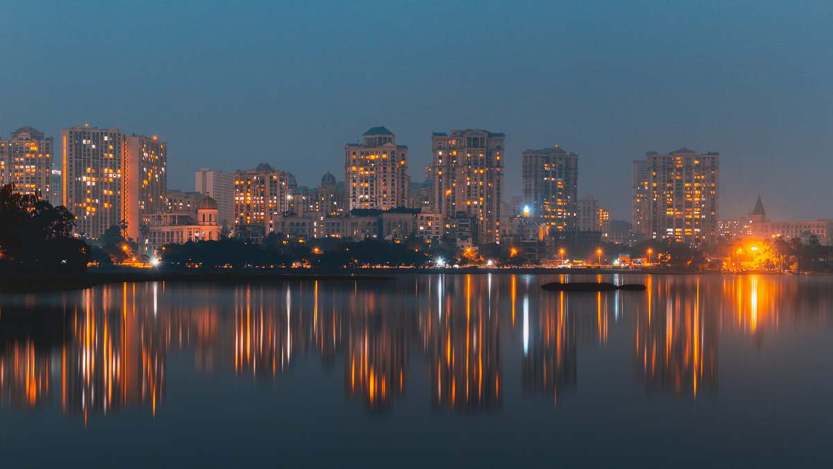 city city with high-rise buildings near body of water during night time urban