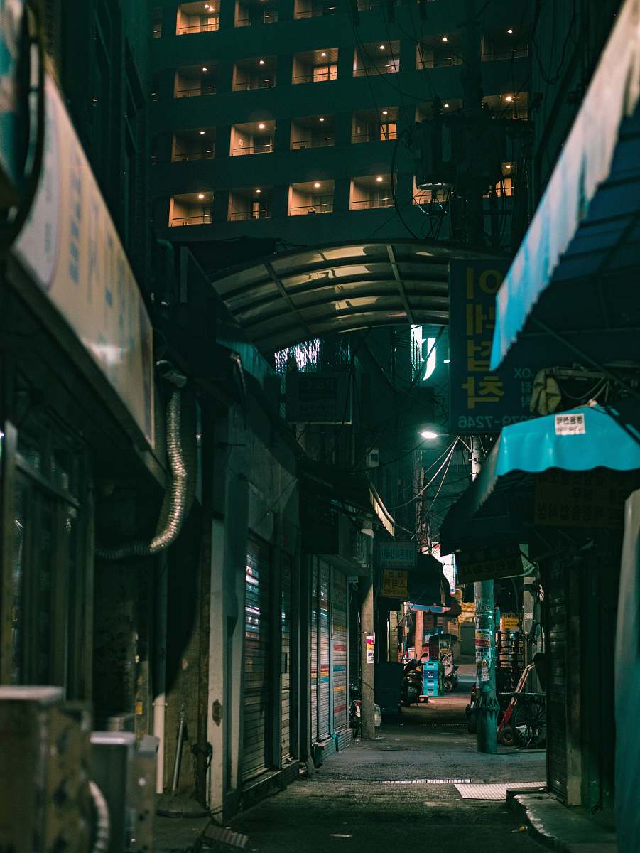 city concrete buildings during nighttime road