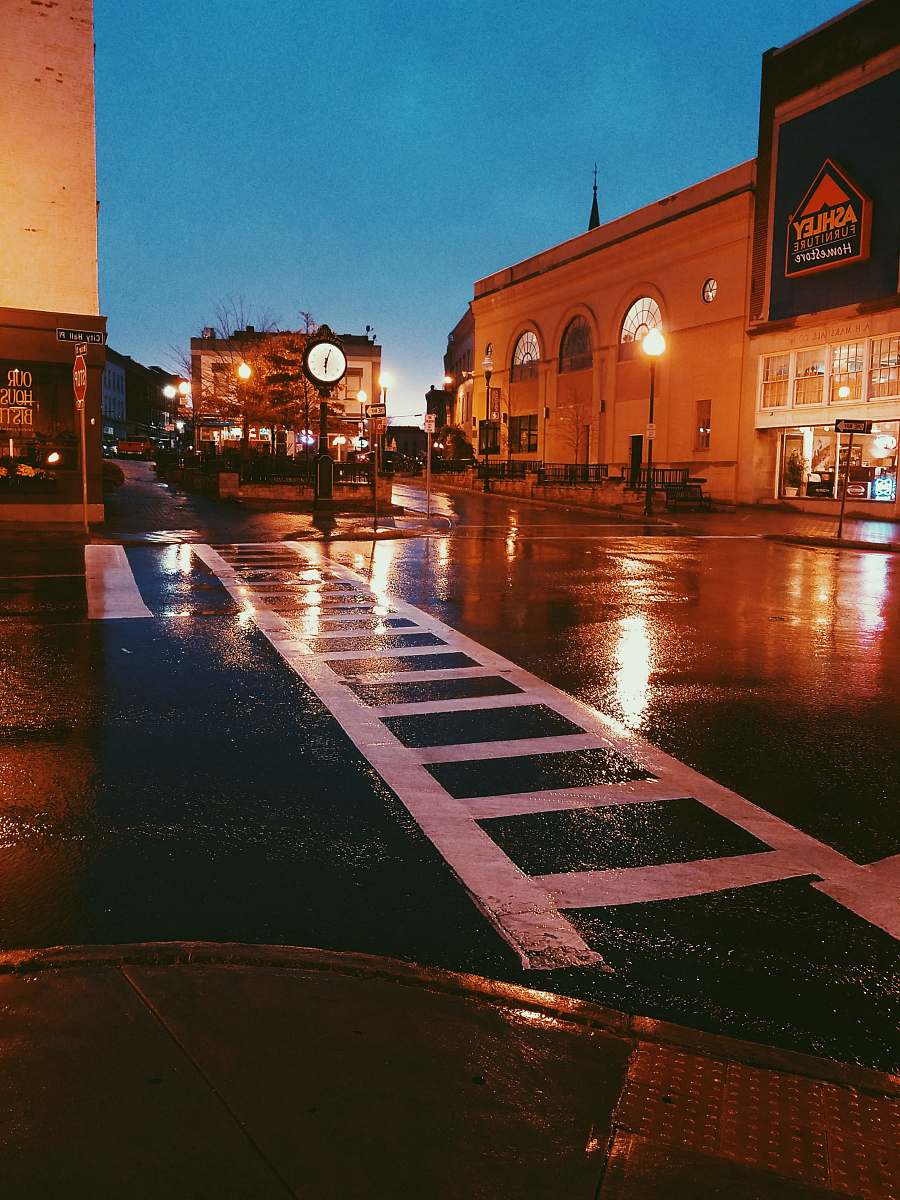 city concrete road near buildings at nighttime urban
