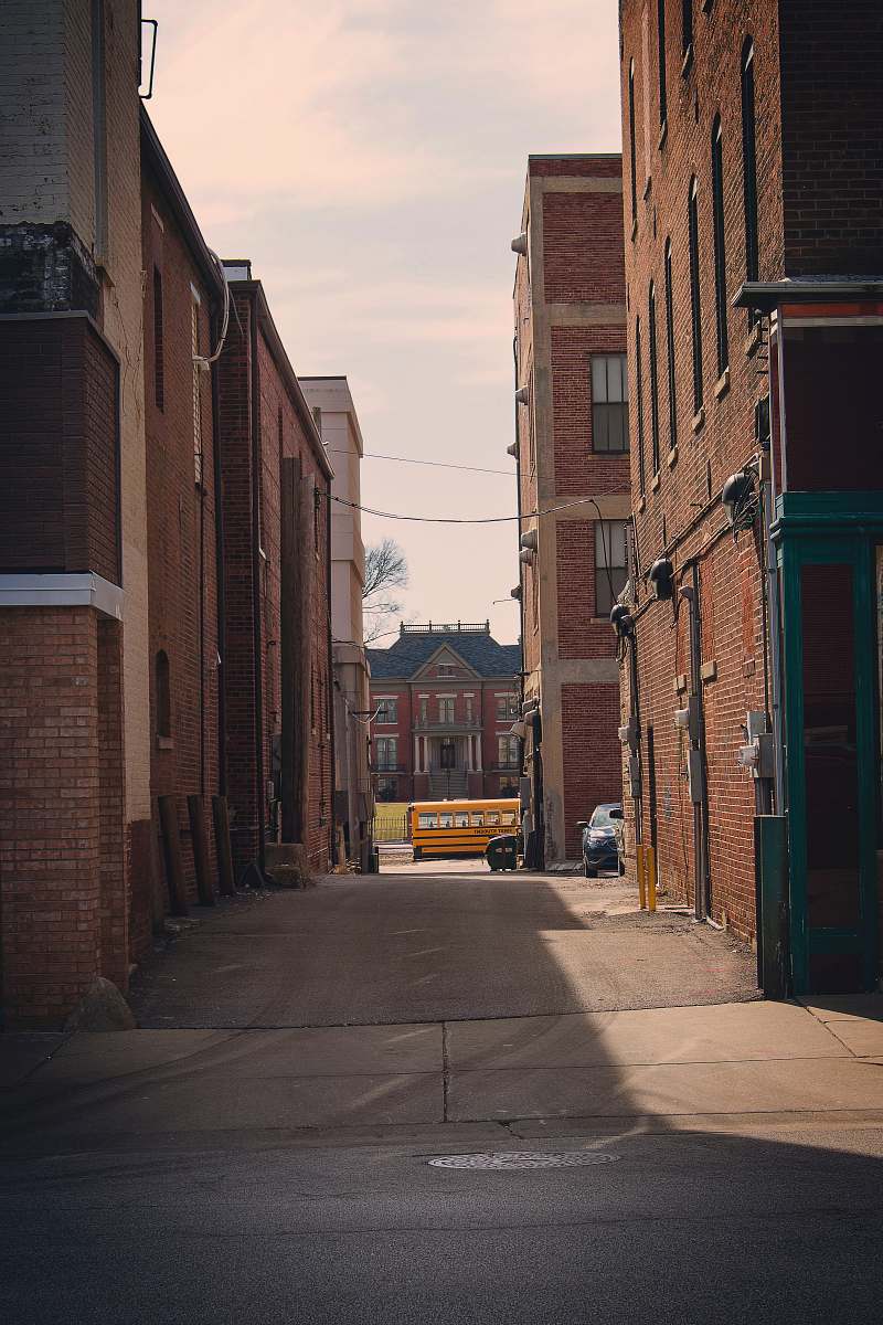 city empty alley between buildings road