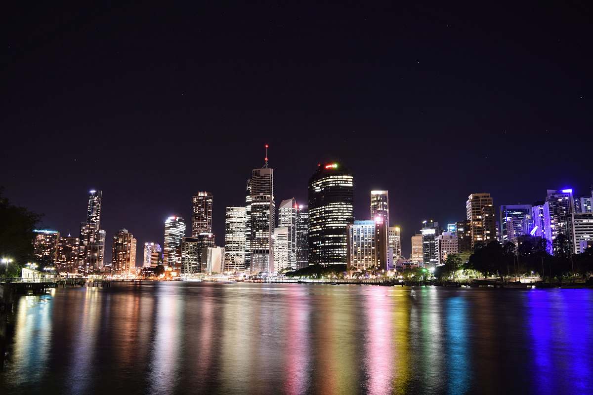 city gray and black high rise buildings and body of water town
