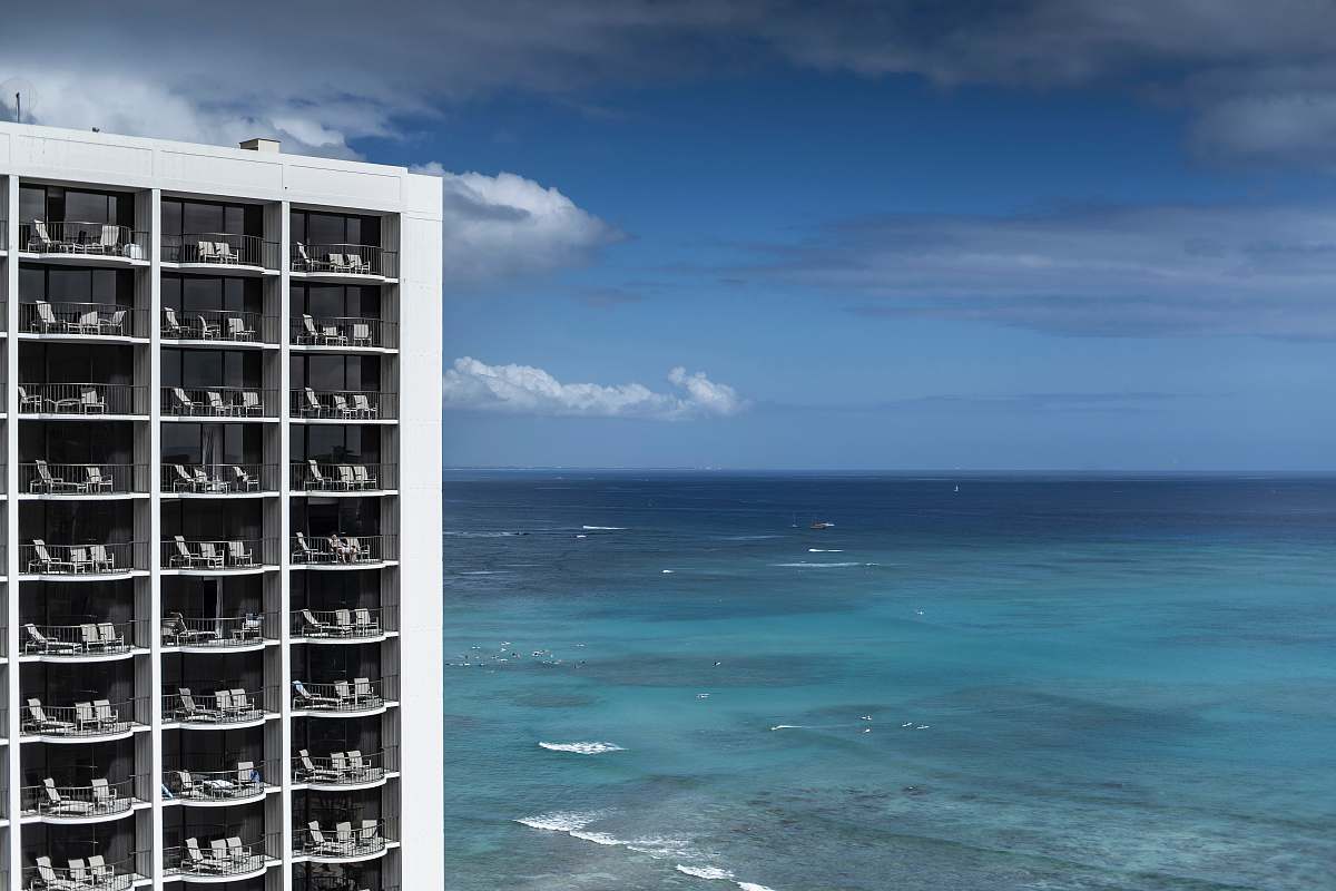 town gray and white concrete building beside beach during daytime urban