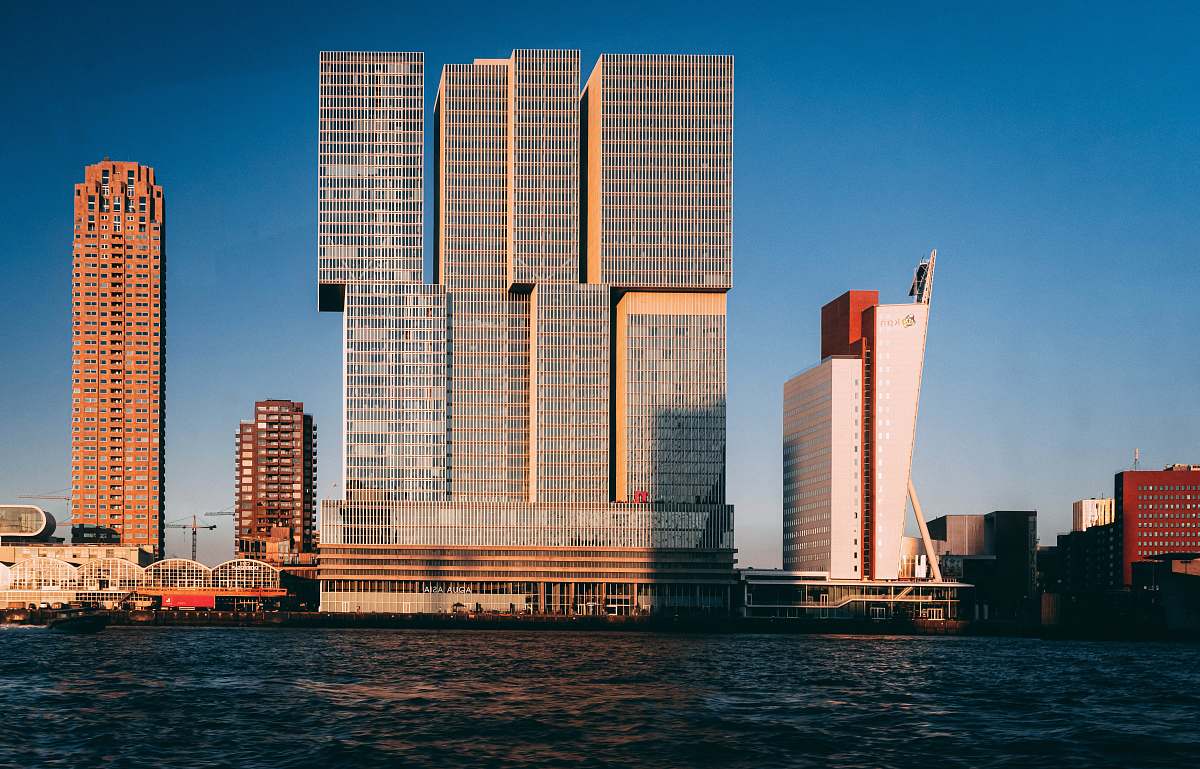 city gray concrete building near body of water high rise