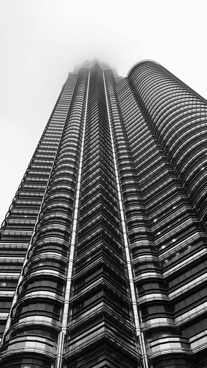 city grayscale low-angle photo of high-rise building black-and-white