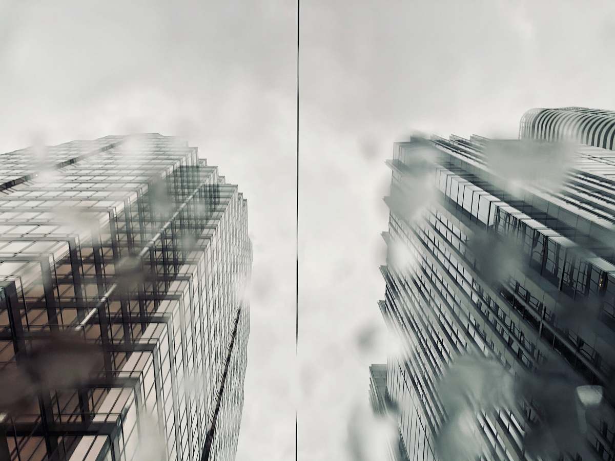 city grayscale photo of 2 buildings high rise