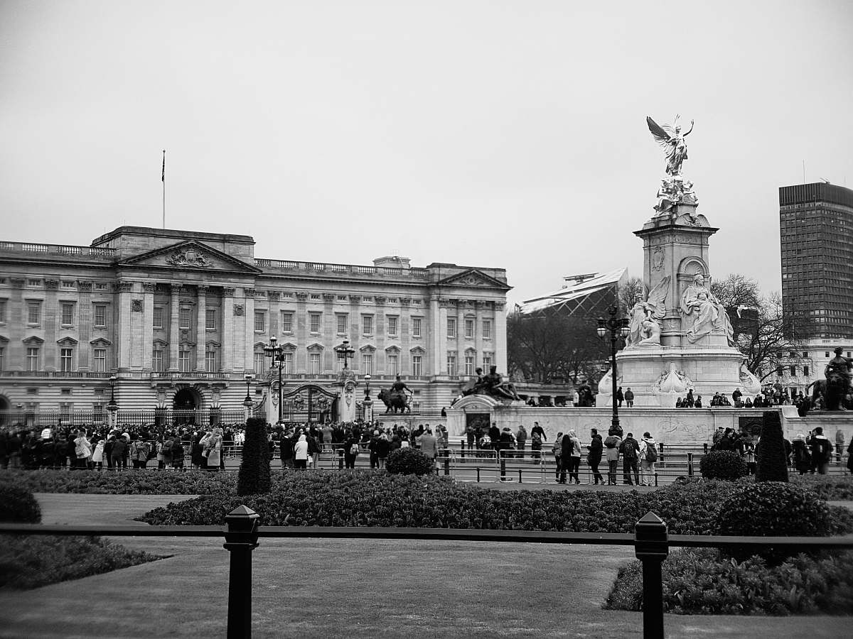 city grayscale photo of people near building black-and-white