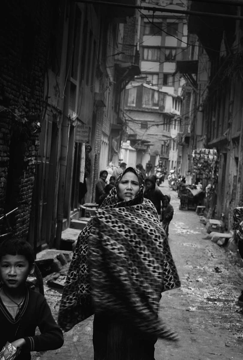 urban grayscale photo of woman wearing hijab headdress black-and-white