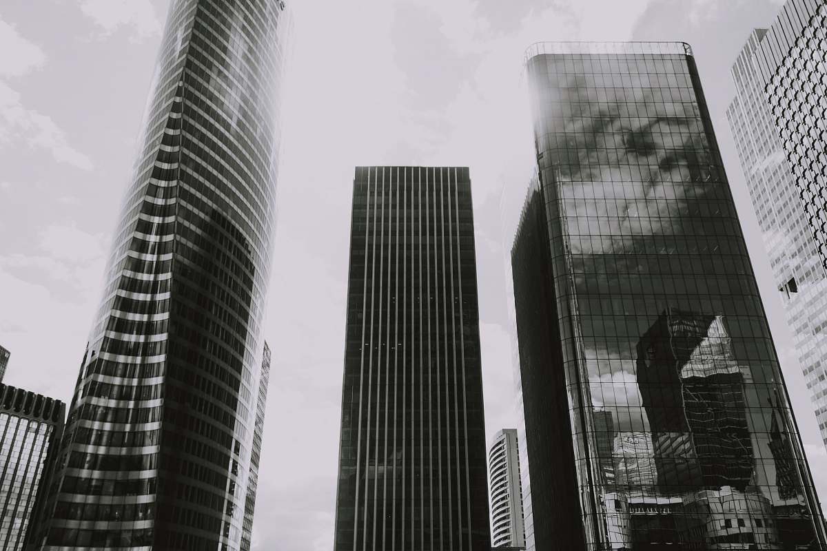 city grayscale photography of curtain-wall high-rise buildings high rise