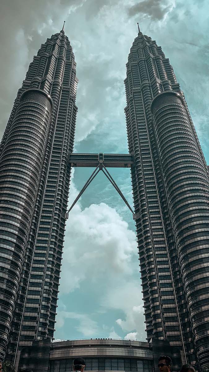 city grey concrete twin tower during daytime high rise