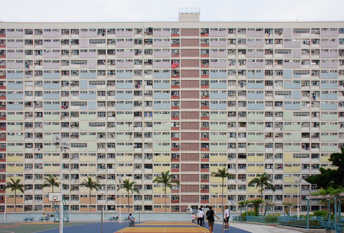 city group of people walking near concrete building high rise