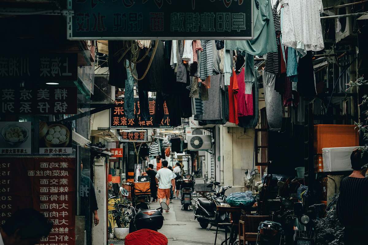 city hanged assorted-color clothes road