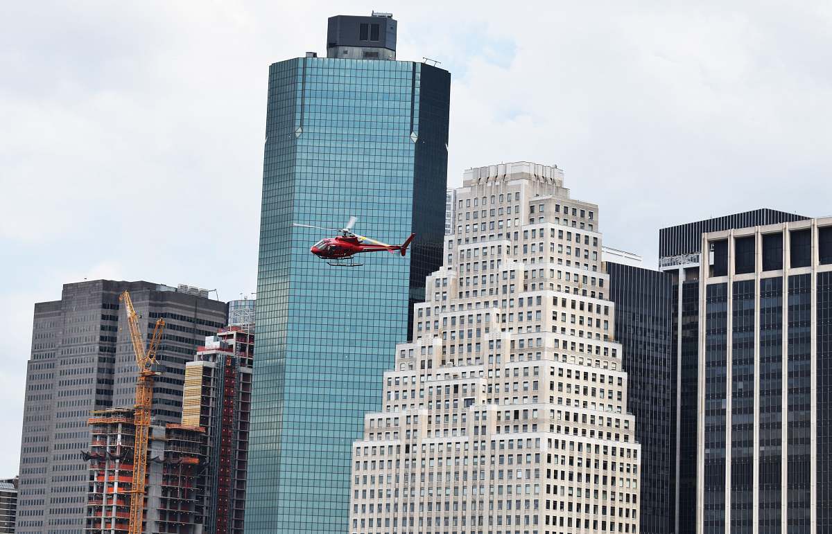 urban helicopter flying around high-rise buildings office building