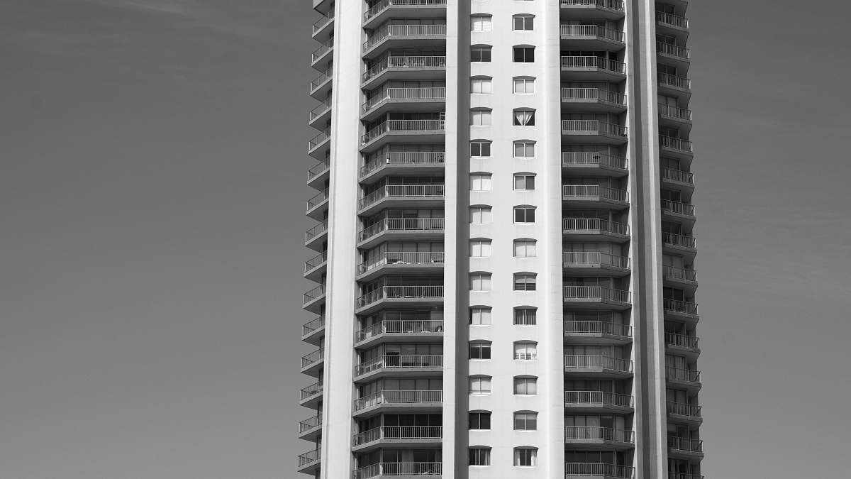 city high-rise building during day black-and-white
