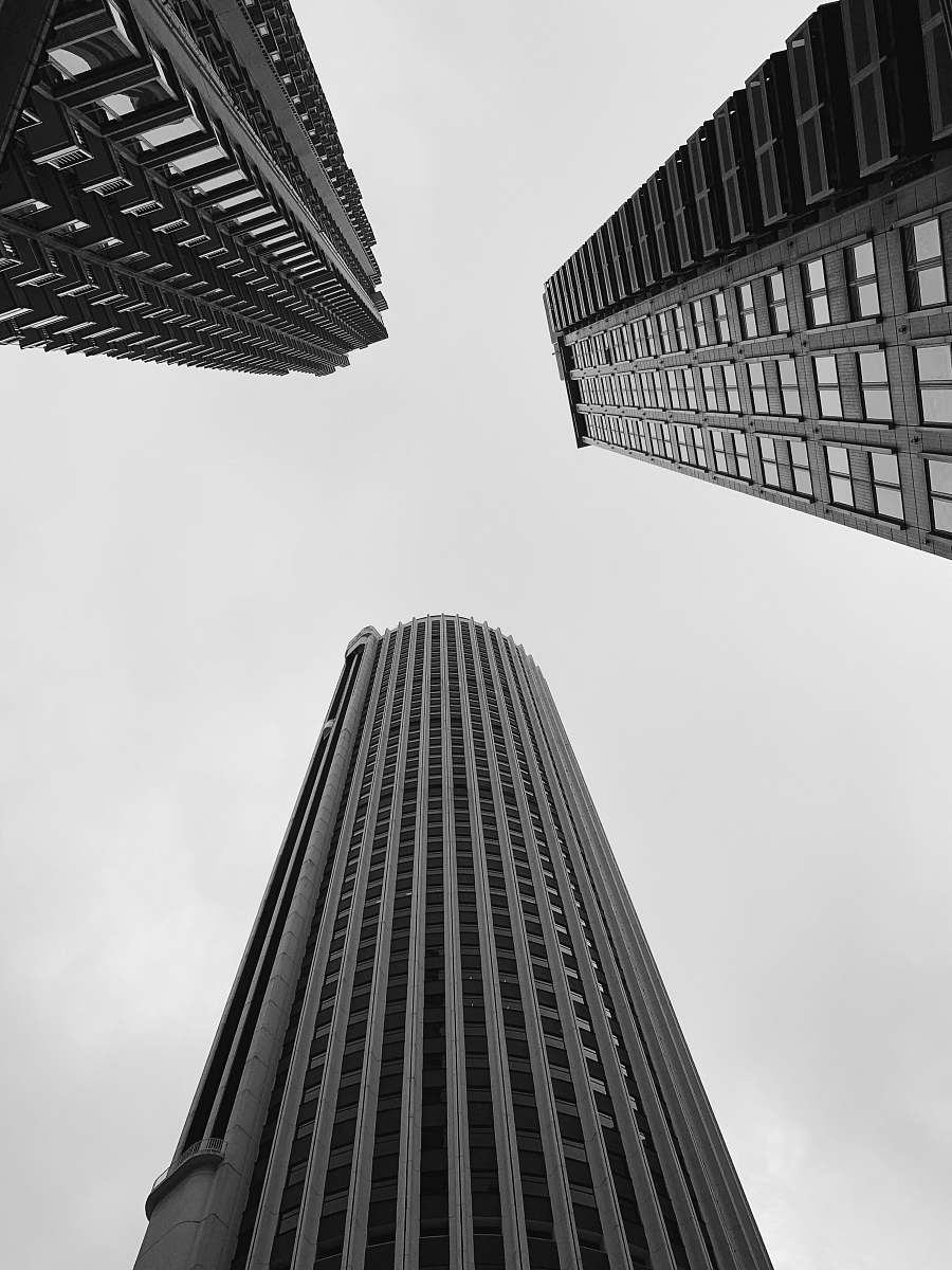city high rise building low angle photography black-and-white