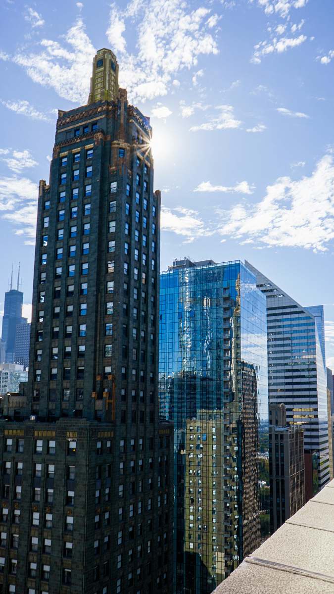 city high-rise building under cloudy sky high rise
