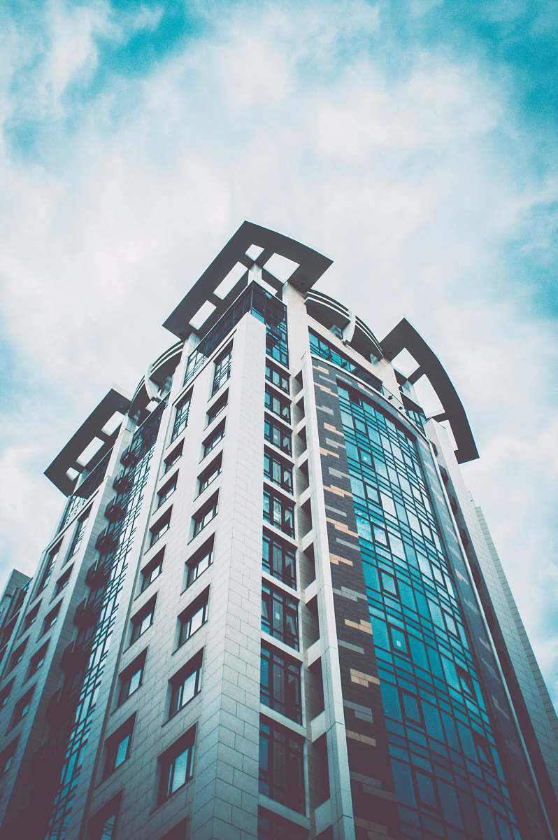 condo high rise building under white sky during daytime housing
