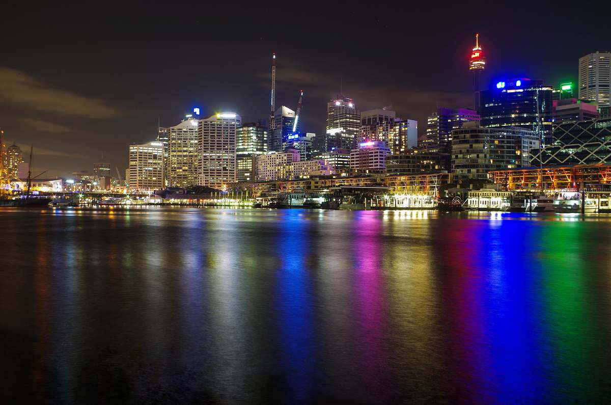 city lighted city beside sea water