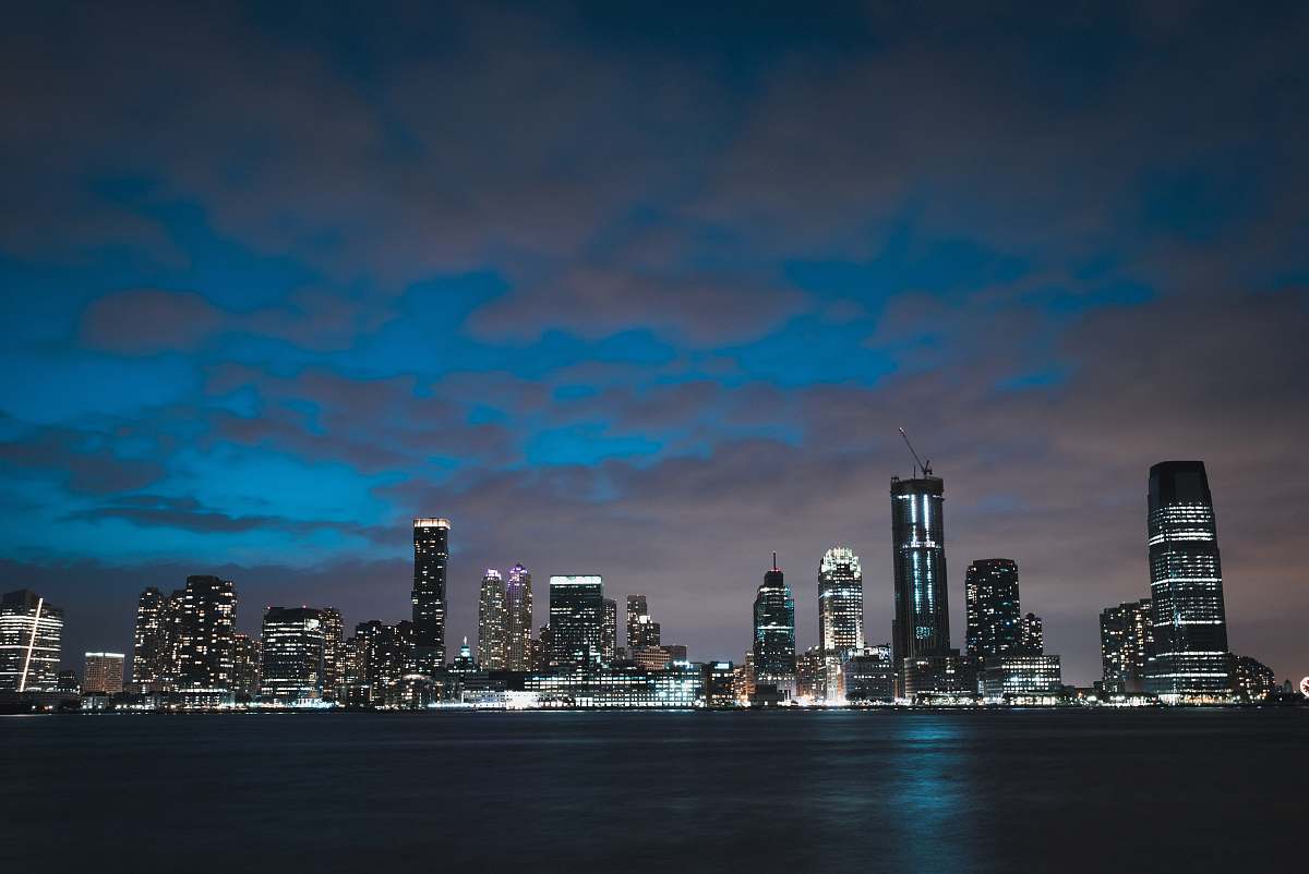 city lighted high rise buildings at nighttime urban