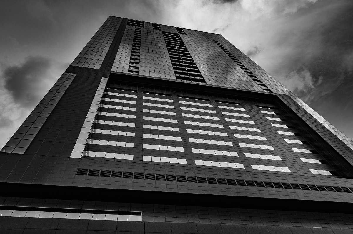 city low angle and grayscale photo of high-rise building black-and-white
