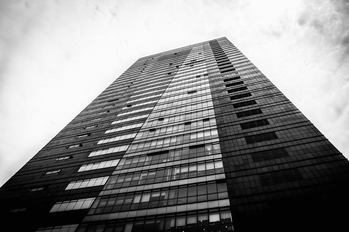 black-and-white low angle photo of black and gray building office building