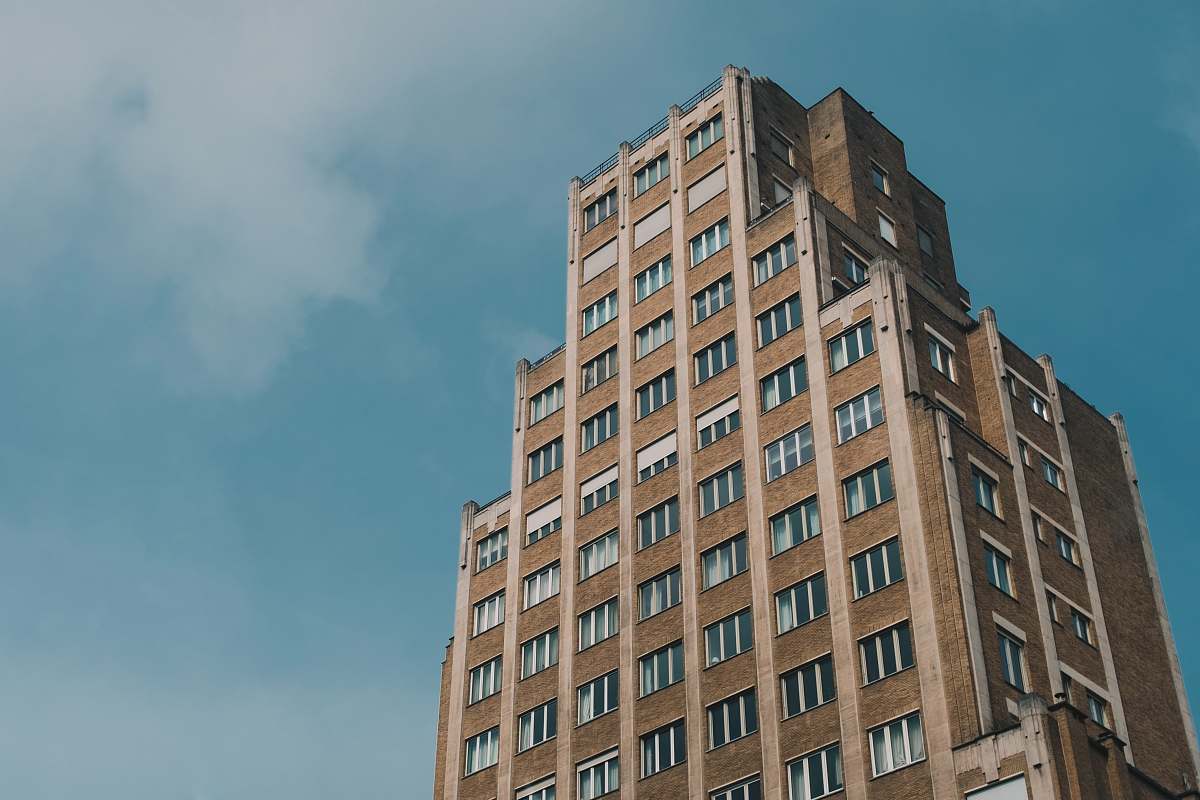 city low-angle photo of brown high-rise building during day time high rise