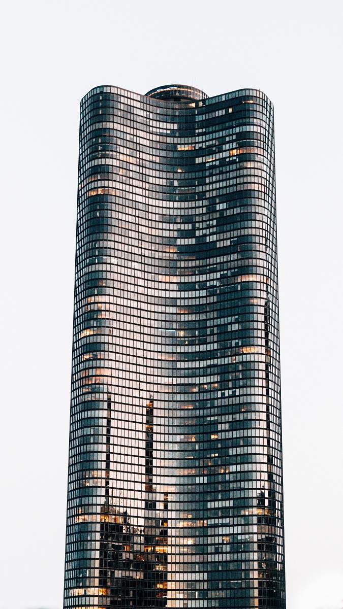 condo low angle photo of curtain glass wall building housing