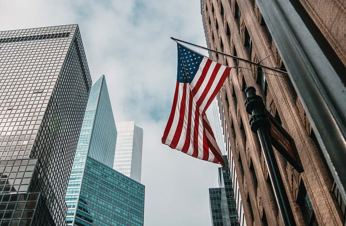 city low angle photo of flag of U.S.A architecture