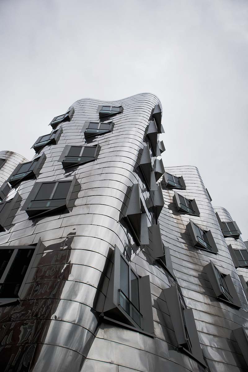 city low-angle photography of building facade black-and-white