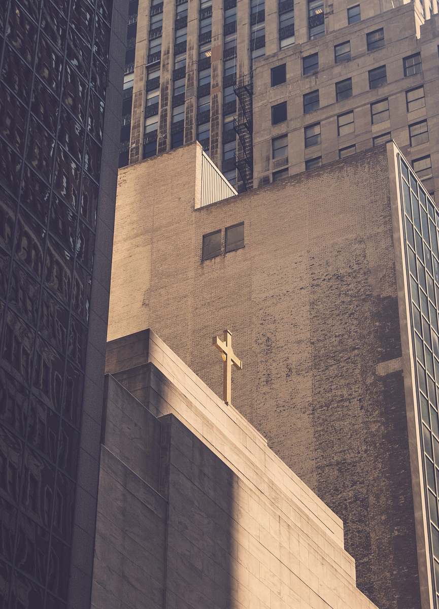 city low angle photography of concrete building with cross urban
