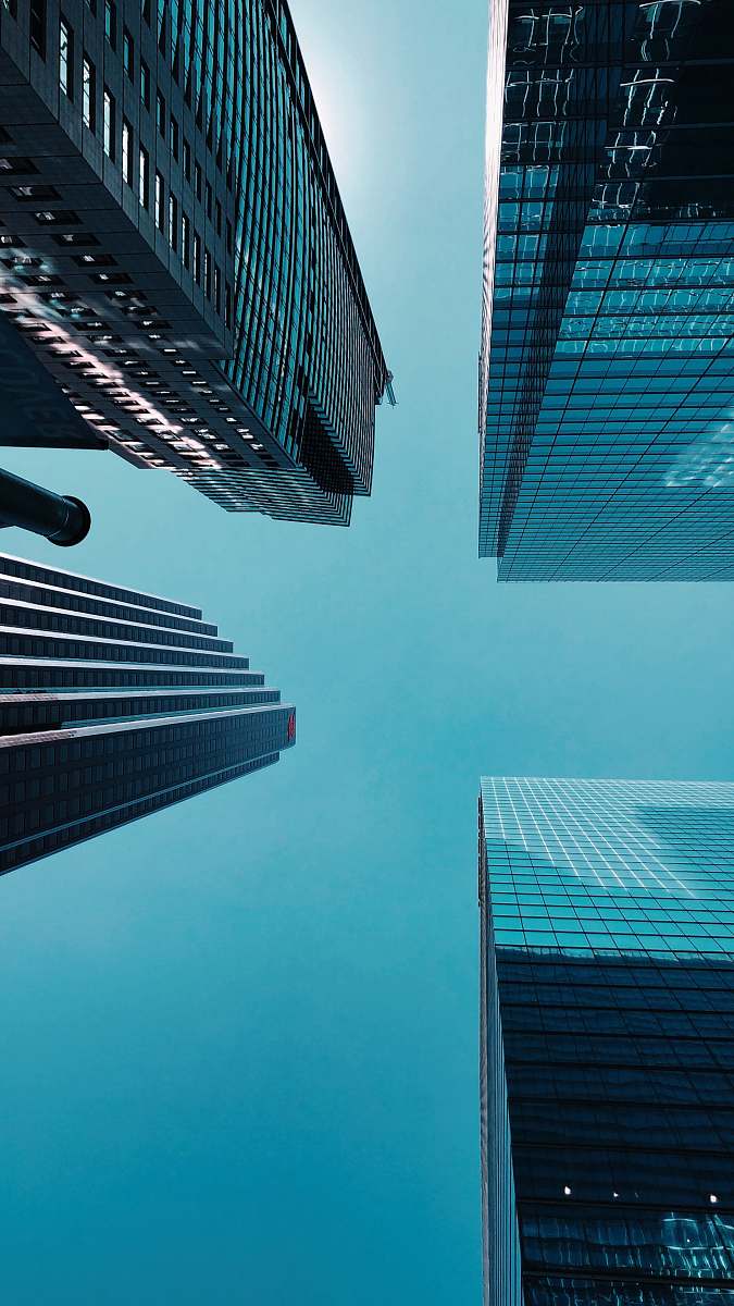 city low angle photography of four gray concrete buildings urban