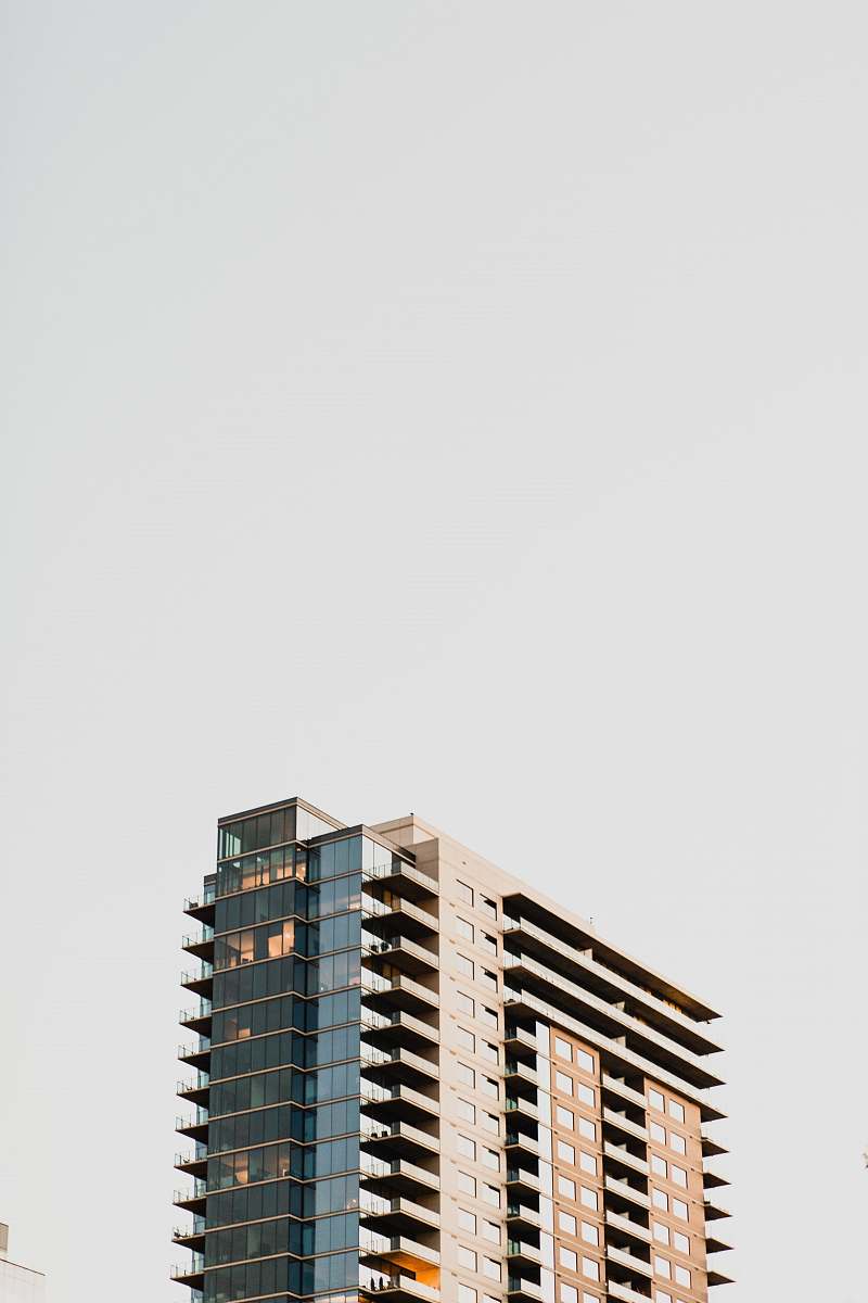 urban low-angle photography of gray and brown concrete high-rise building during daytime town