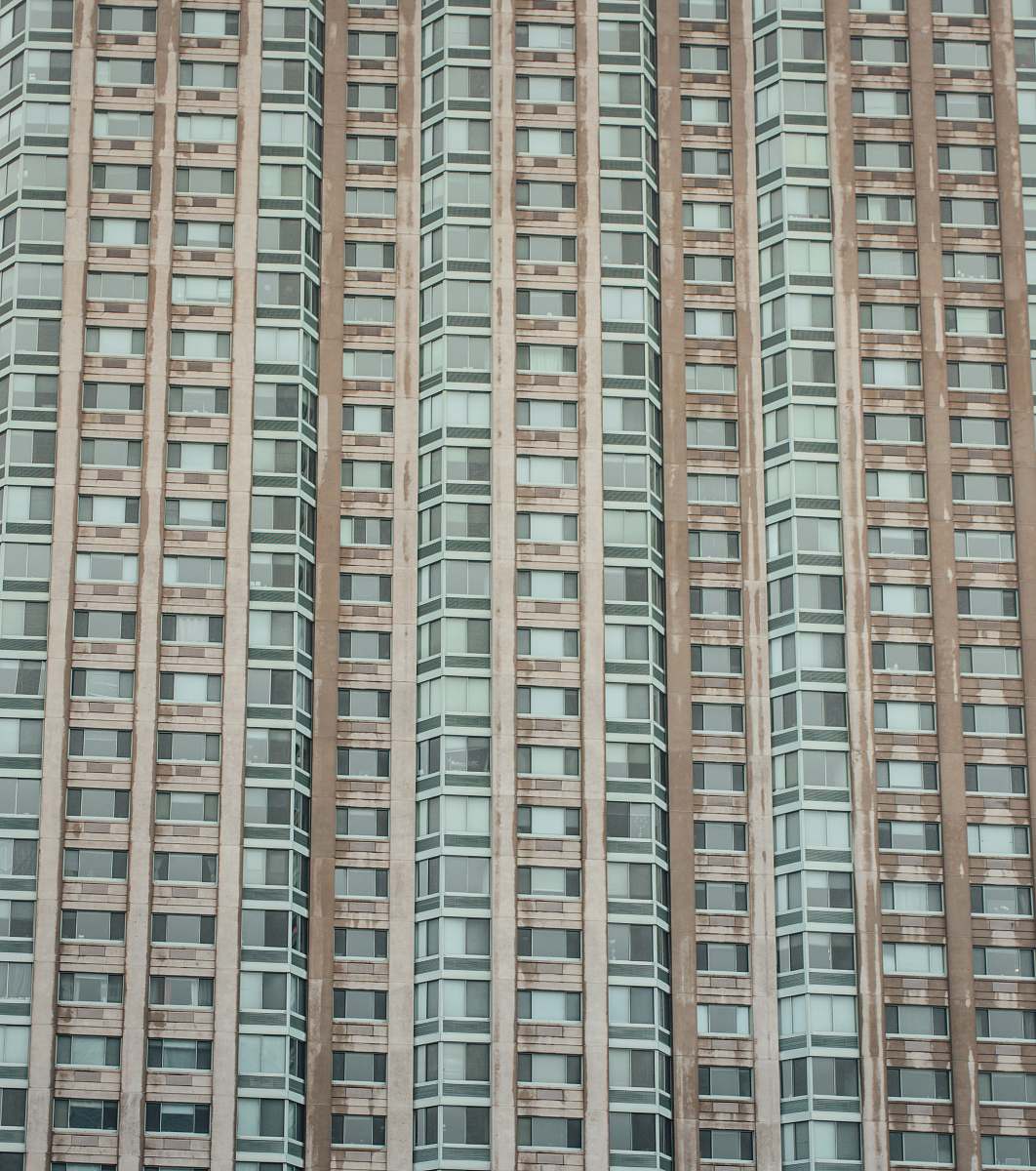 city low-angle photography of gray concrete high-rise building during daytime high rise