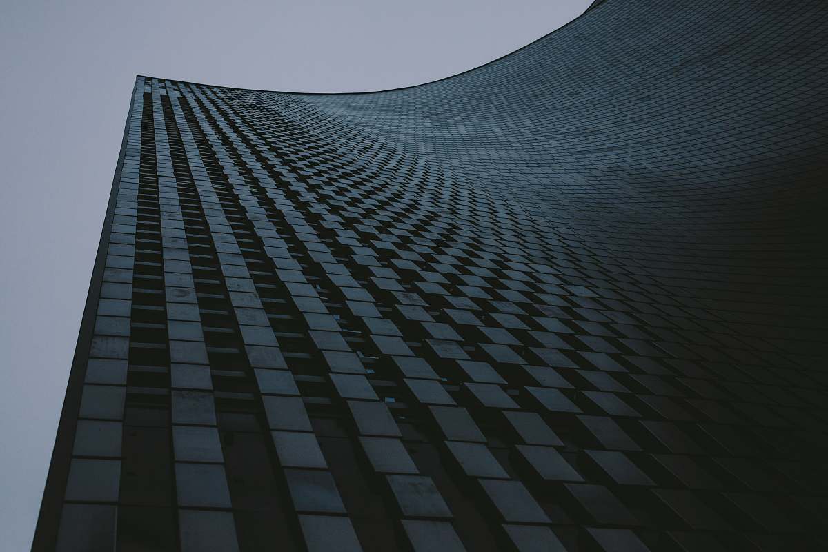 city low-angle photography of high-rise building under gray sky architecture
