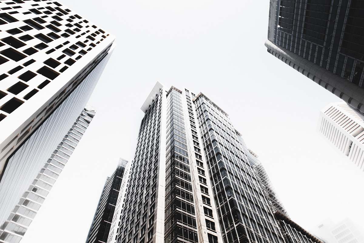 city low angle photography of highrise buildings black-and-white