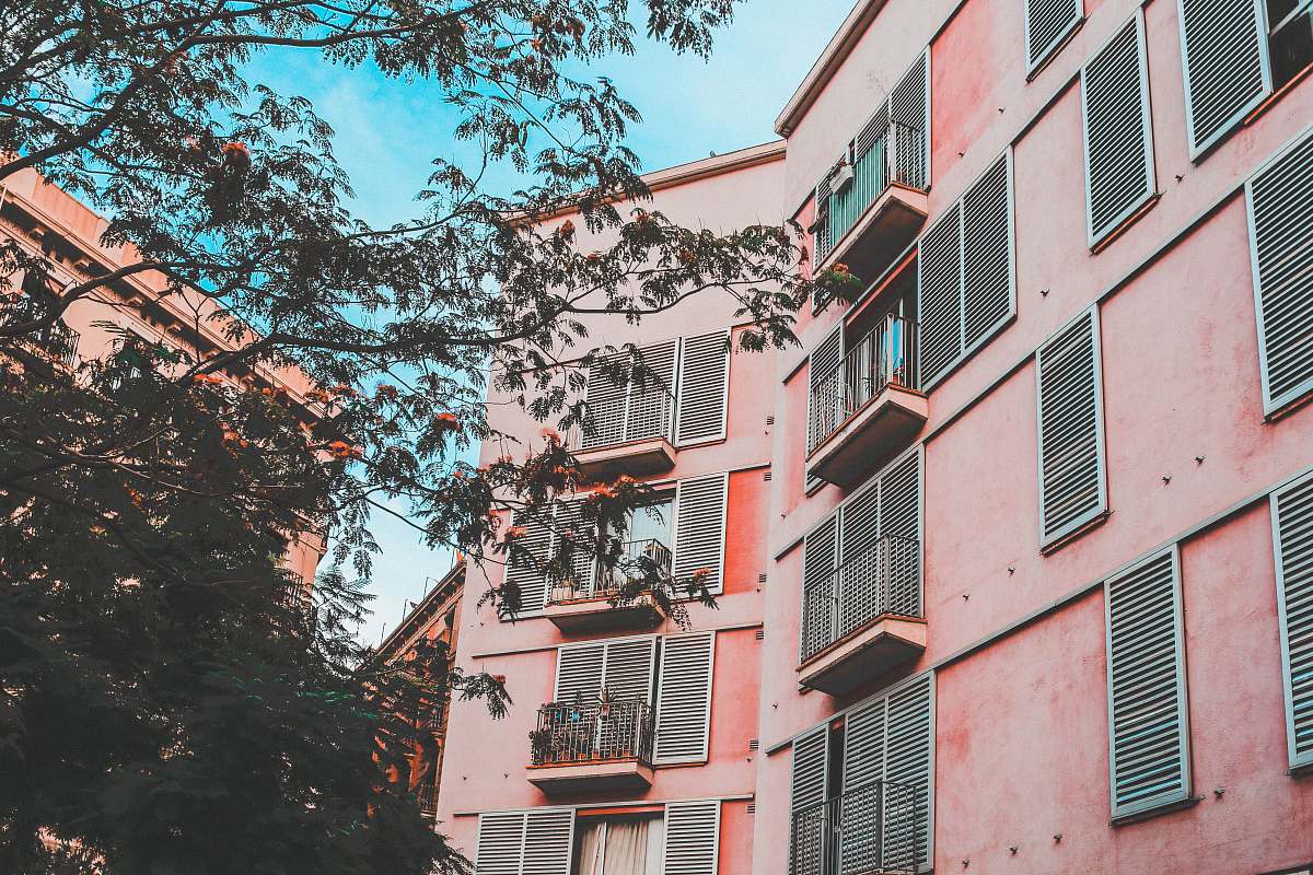city low-angle photography of pink concrete apartment during daytime home decor