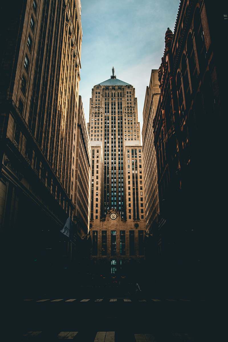 city low angle photography of road straight to high-rise building under white and blue cloudy skies chicago