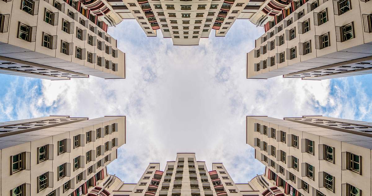 city low angle photography of two white concrete buildings high rise