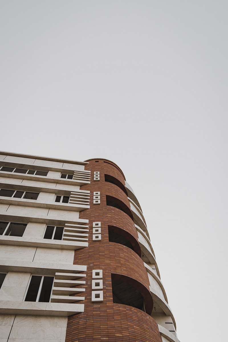 city low-angle photography of white and brown building high rise