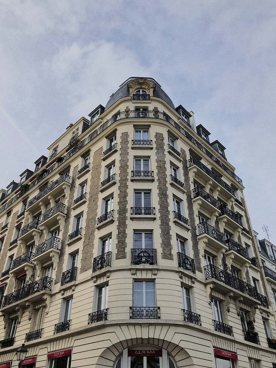 city low-angle photography of white concrete building high rise
