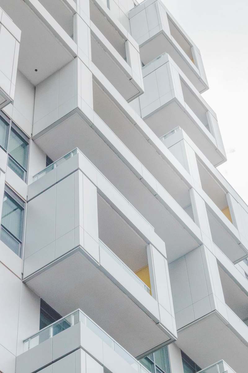city low-angle photography of white concrete multi-storey building urban