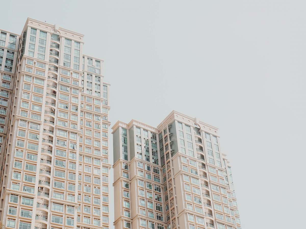 city low-angle photography of white high-rise buildings high rise