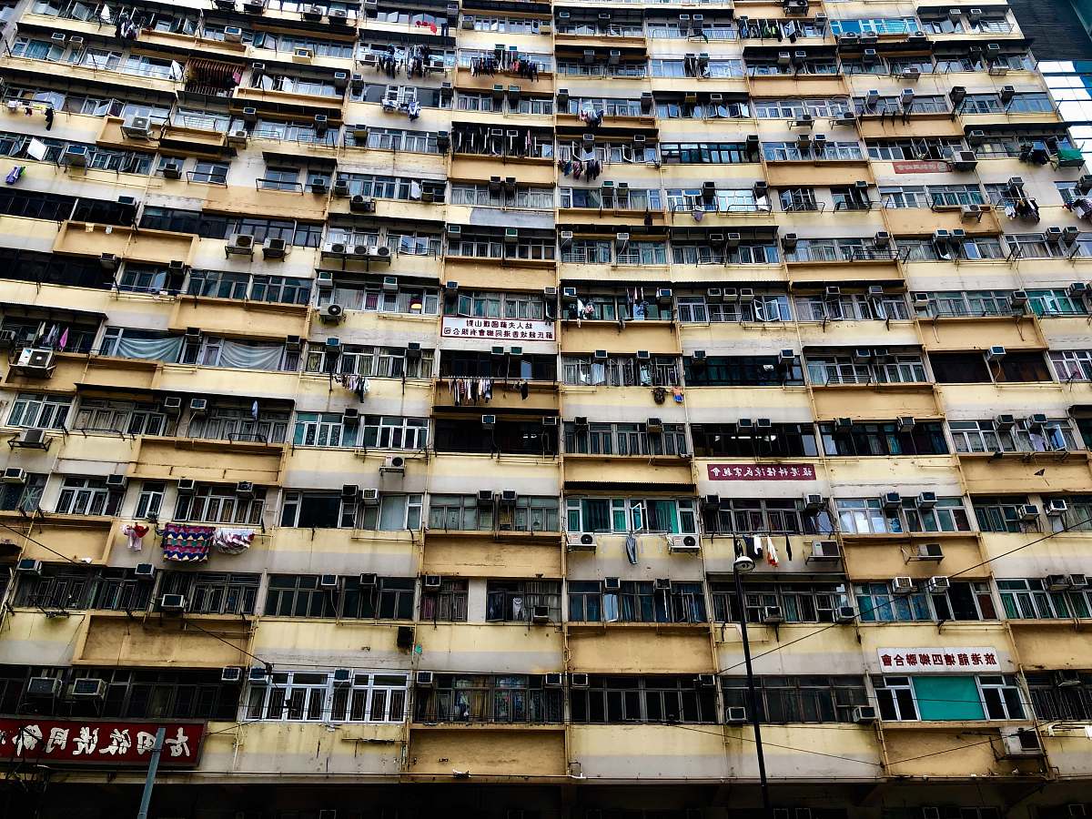 city low-angle photography of yellow concrete building high rise