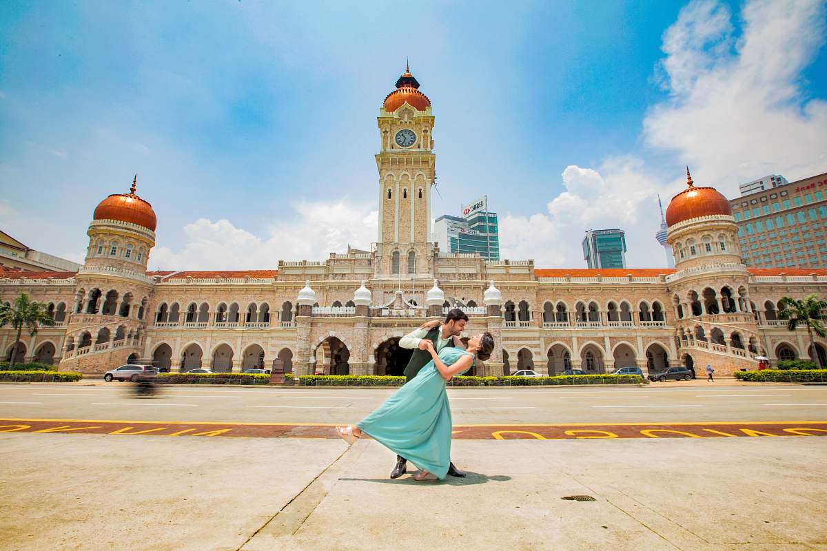 city man and woman dancing near building] downtown
