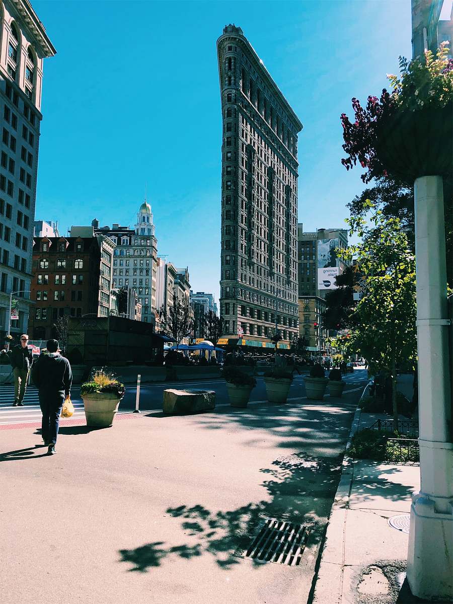 city man in black shirt walking on street downtown