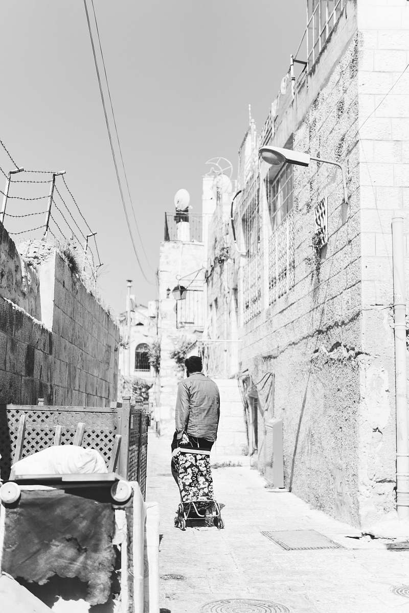 city man on walkway in grayscale photo black-and-white
