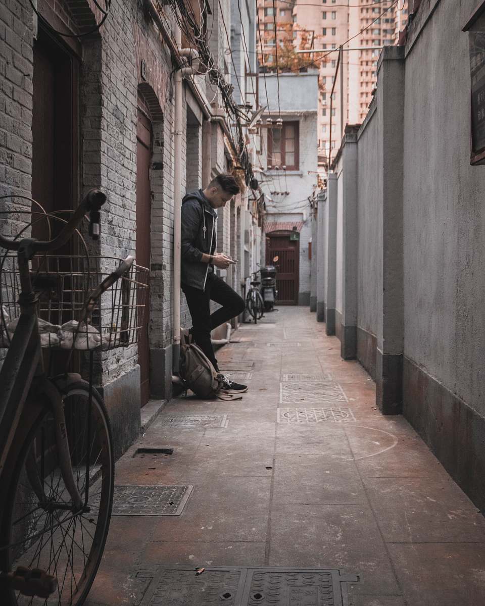 city man standing near wall road