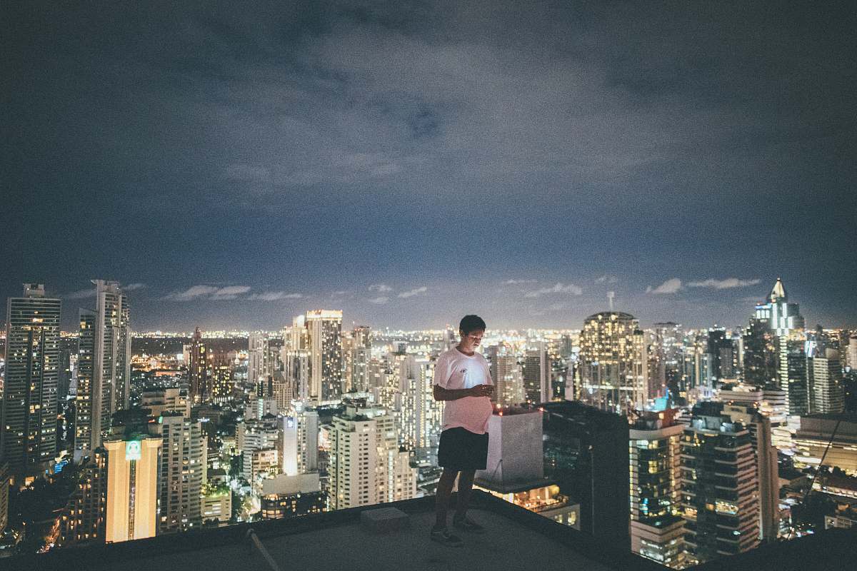 city man standing on top of buidling urban