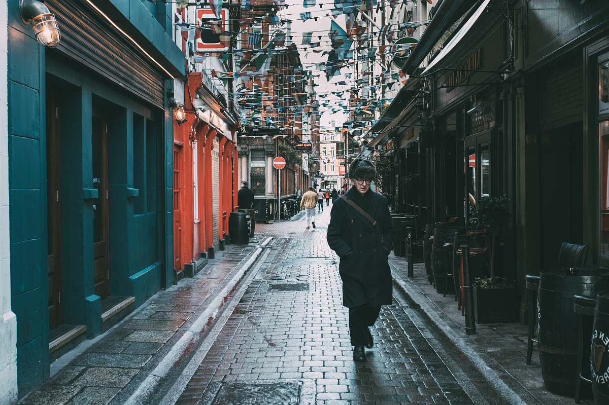 city man walking on alley road