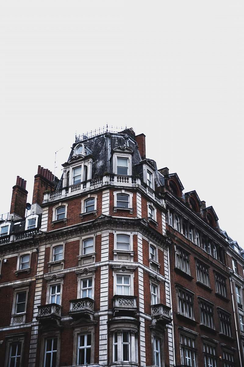 city maroon and white concrete mid-rise building under white sky urban