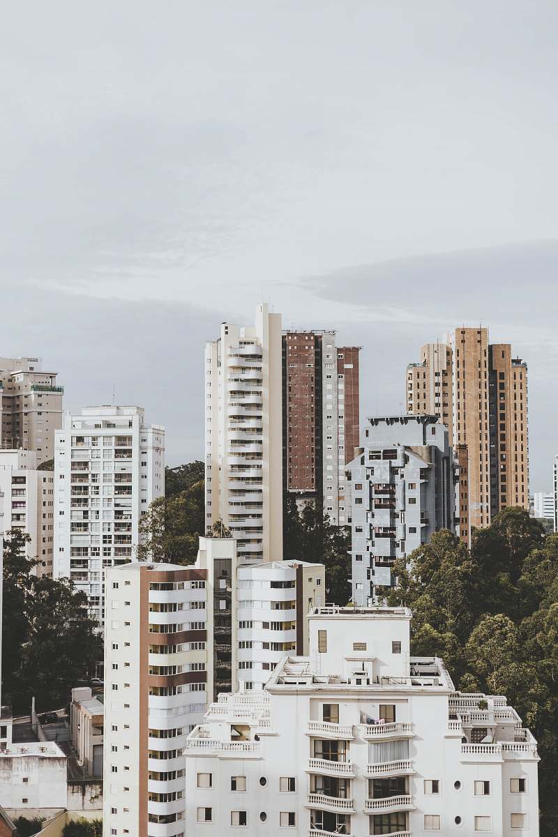 city mid-rise and high-rise buildings under gray sky high rise